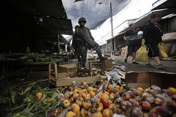 Chile security: Soldiers patrol a market to prevent looting in Hualpen, Chile