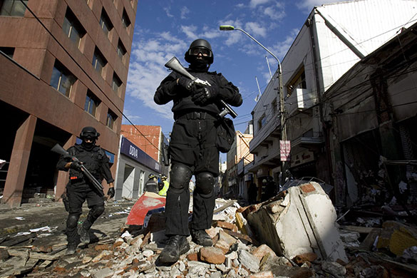 Chile security: Police patrol in a street during the curfew at the port city of Talcahuano