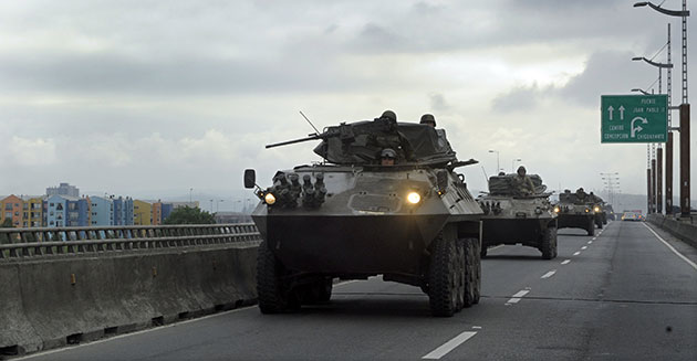 Chile security: Chilean Army armoured personnel carriers drive on the Juan Pablo II bridge