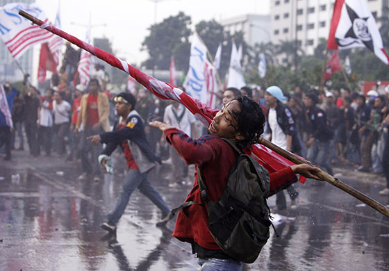 24 hours: Jakarta , Indonesia: A protester throws a pole towards police 