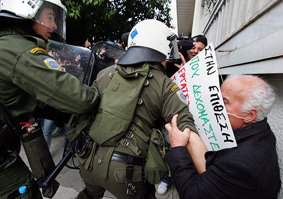 Greece protests: Pensioners try to brake through the police barrier, Athens, Greece