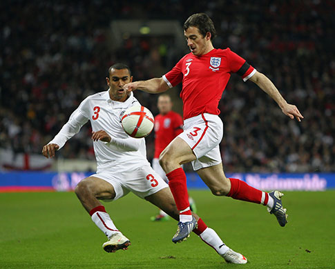 England v Egypt: Leighton Baines of England clears the ball away from Ahmed Al-Muhammadi