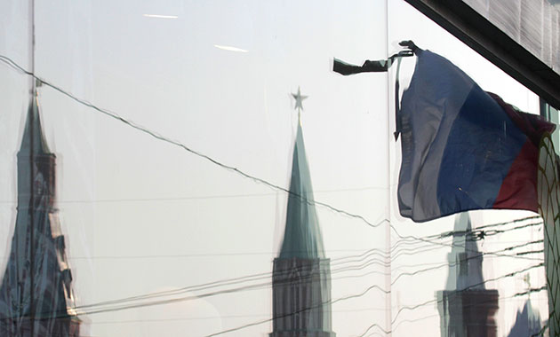 moscow bombs aftermath: A Russian national flag with a black ribbon on a day of mourning in Moscow
