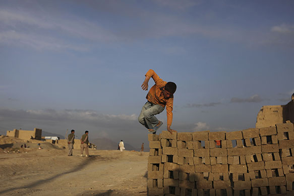 24 hours in pictures: Kabul, Afghanistan: A boy plays in a brick factory