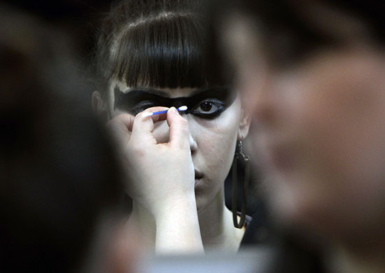 24 hours in pictures: Tbilisi, Georgia: A model has make-up applied backstage during Fashion Week