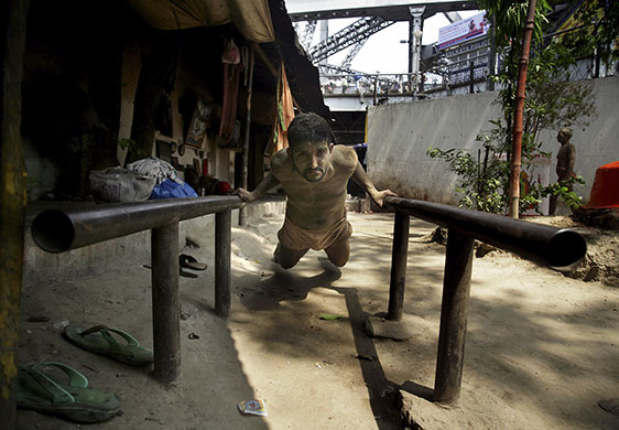 24 hours in pictures: Calcutta, India: A traditional wrestler exercises during a practice session