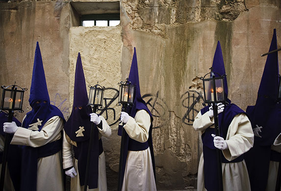 24 hours in pictures: Zamora, Spain: Penitents wait to take part in a procession