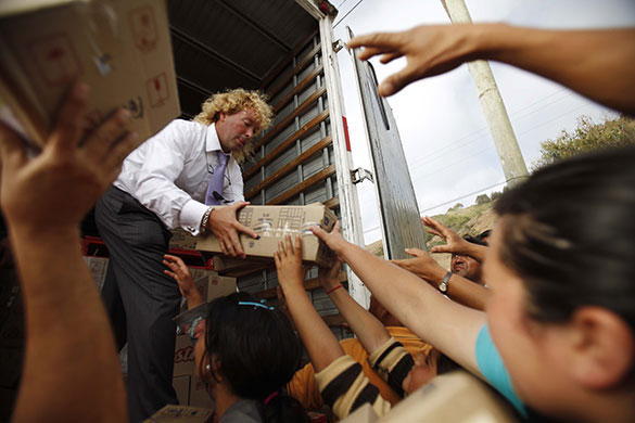 Chile Aid: Chilean businessman Leonardo Farkas distributes food to residents in Chile