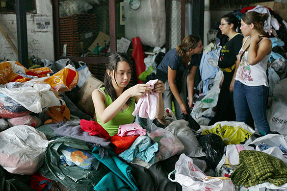 Chile Aid: A volunteer organizes bags of clothes from the Chilean Red Cross