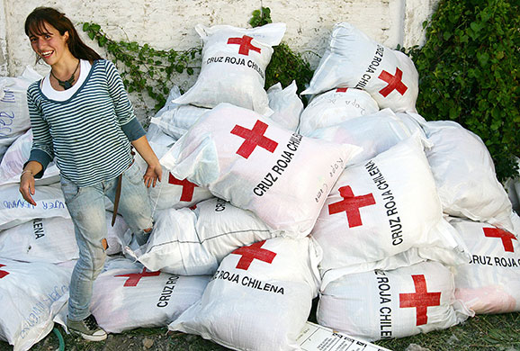 Chile Aid: A volunteer organizes bags of clothes from the Chilean Red Cross