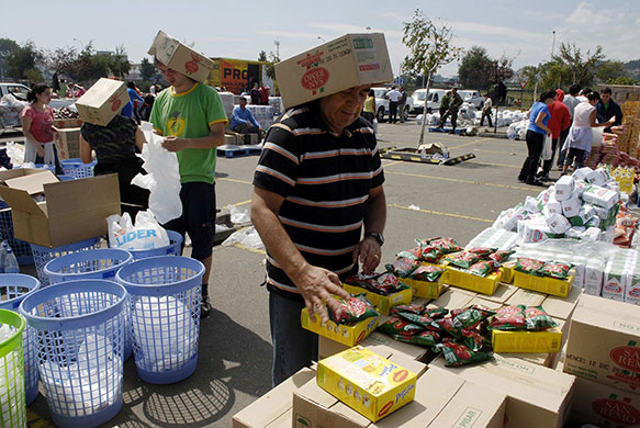 Chile Aid: Workers separate donated food into packages for distribution in Chile