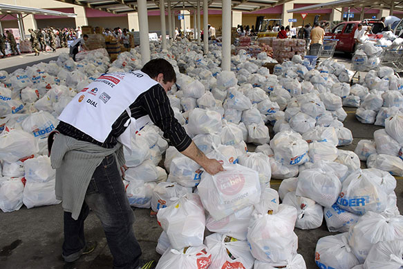 Chile Aid: Workers separate donated food into packages for distribution in Chile