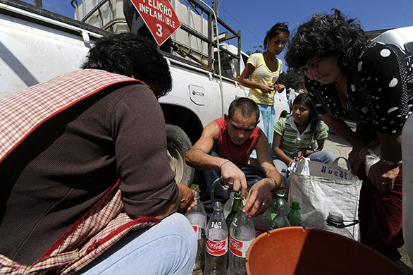 Chile Aid: Members of the Chilean Agriculture Ministry distribute drinking water