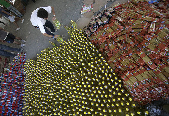 Chile Aid: A volunteer sorts bottles of cooking oil in Chile
