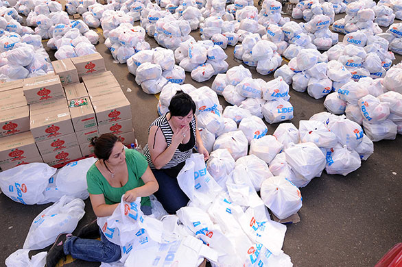 Chile Aid: Volunteers pack food donated for Saturday's earthquake victims in Chile