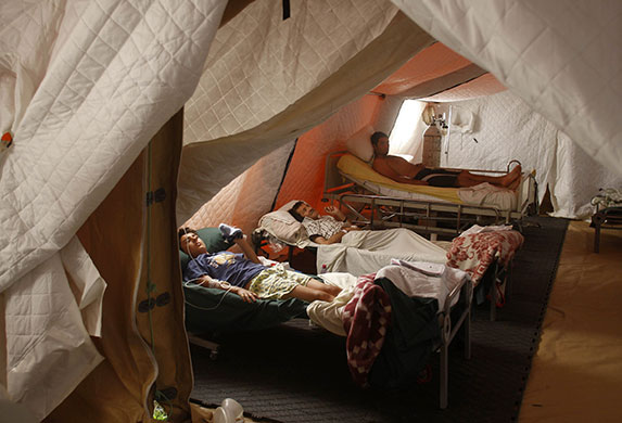 Chile Aid: March 1, 2010: Earthquake victims lie in beds in a field hospital