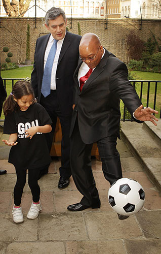 Zuma visits UK: Jacob Zuma kicks a football with a school girl and Gordon Brown