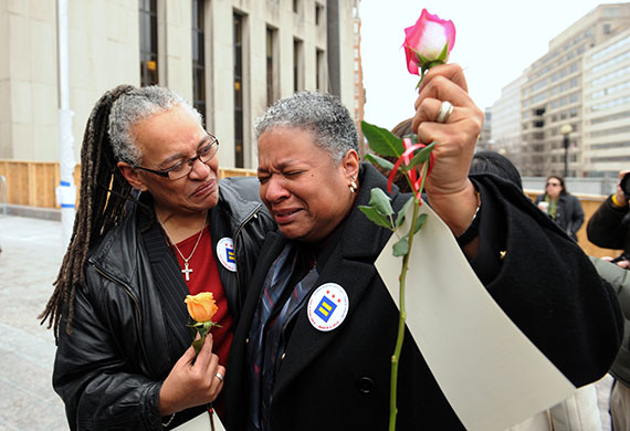 Gay weddings: Candy Holmes, right, cries with joy beside her partner Darlene Garner