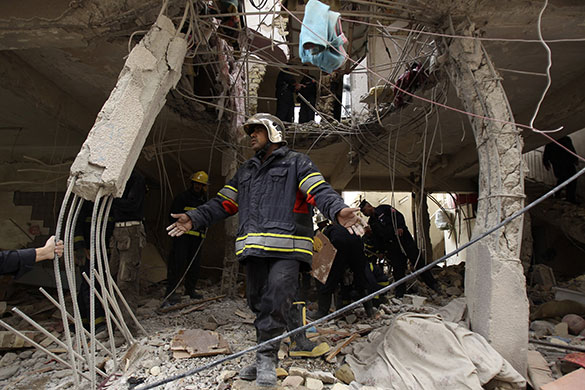 Iraq elections build up: Iraqi civil defence inspect damaged building after a bomb attack in Baghdad