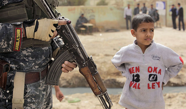 Iraq elections build up: An Iraqi tactical support officer standing guard outside a polling station