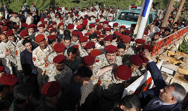 Iraq elections build up: Iraqi army soldiers line up to cast their votes at a polling in Baghdad