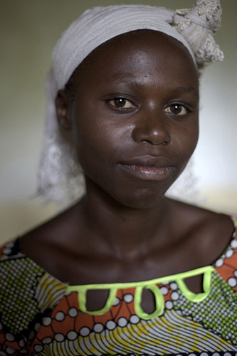 Women Health Workers: An African teenager smiles at the camera