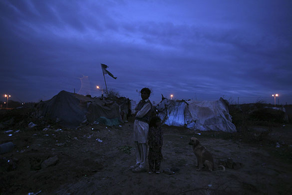 24 hours in pictures: Islamabad, Pakistan: A family's makeshift tents