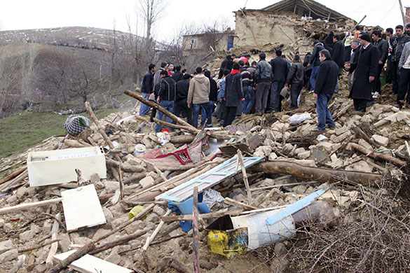 Turkey earthquake: Rescue workers and residents remove rubble from a destroyed house