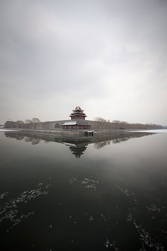 24 hours in pictures: Beijing, China: Snowfall dusts the roofs and moat around the Forbidden City