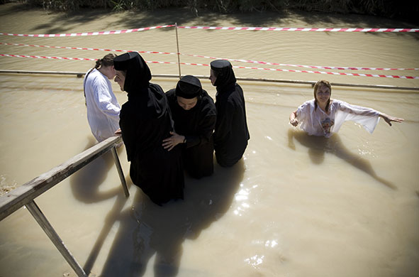 Holy week: Orthodox Christians immerse themselves in the Jordan River