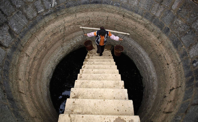 Drought in South China: A villager carries water from a well  Shilin County of Kunming, Yunnan