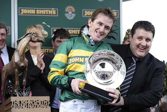 grand national: Tony McCoy smiles as he receives his trophy from comedian Peter Kaye