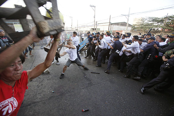 24 hours in pictures:  Striking dock workers clash with security guards and police in Manila