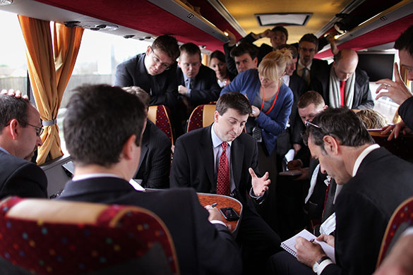 Election campaign week 2: Douglas Alexander, centre, talks to reporters on the tour bus near Rugby