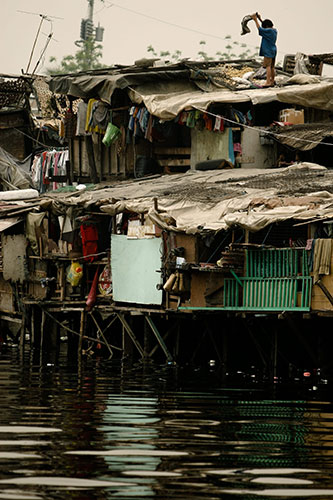 24 hours in pictures: Manila, Philippines: A child dries crops on top of a shanty