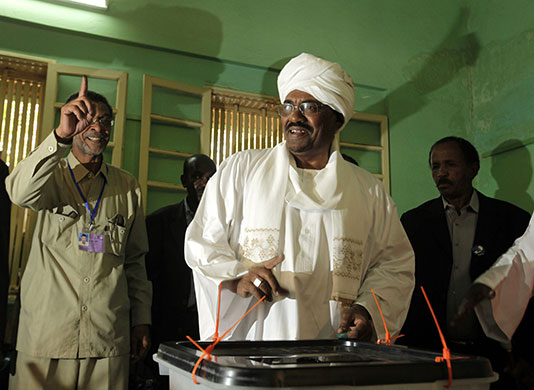 Sudan elections: Members of Sudanese President Omar al-Beshir's entourage shout