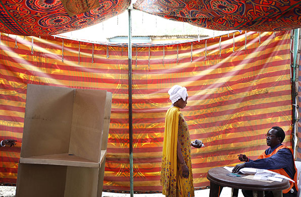 Sudan elections: A Southern Sudanese woman votes at a polling station set in a tent in Juba