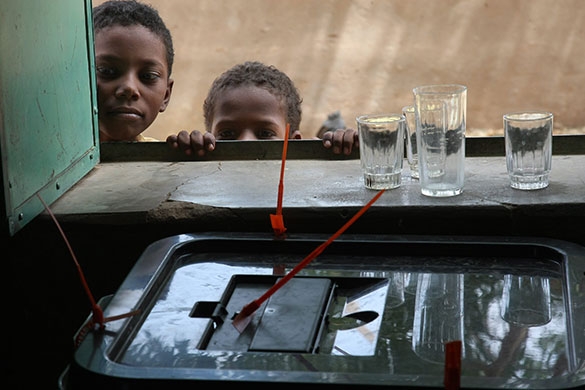Sudan elections: Two boys watch the voting process at the Al Mukdab School