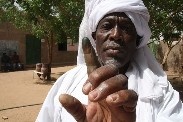 Sudan elections:  A man shows his ink-stained finger after voting at the Oum Ayman School