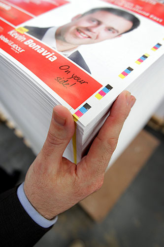 Printing Labour leaflets: An employee of Anton Group Printers checks a finished printed sheet