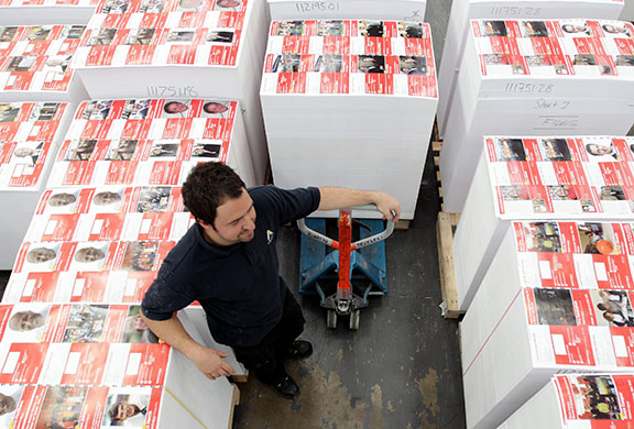 Printing Labour leaflets: Finished printed sheets of Labour Party election material is stacked 