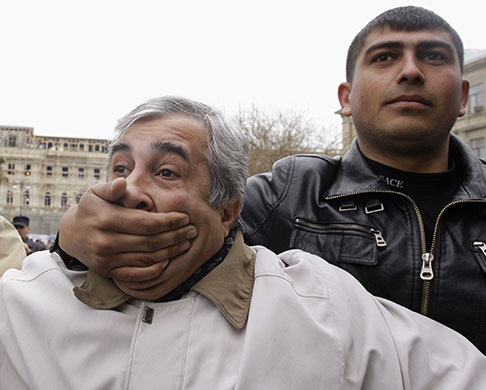 24 hours in pictures: A plain-clothes policeman detains opposition activist in  Baku, Azerbaijan