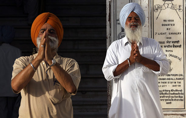 Sikh festivals: Sikh devotees pay obeisance with folded hands, facing the Golden Temple