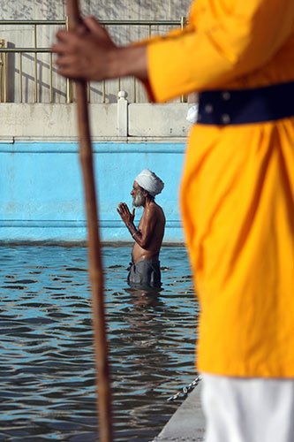 Sikh festivals: A Sikh devotee stands in prayer posture
