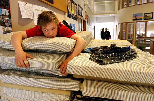 Iceland volcano eruption: A youth lies on mattresses at the South Iceland Care centre
