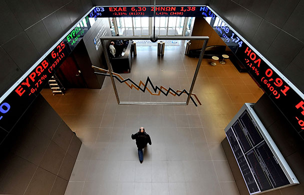Week in business: An employee walks in the Athens stock exchange