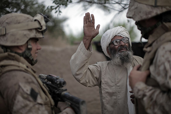 24 hours in pictures: Afghanistan: A farmer answers questions from an interpreter