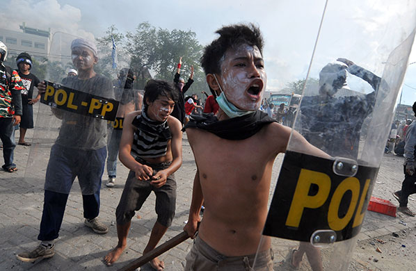 24 hours in pictures: Jakarta, Indonesia: Demonstrators protect themselves with shields