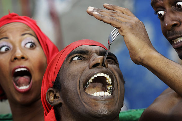 24 hours in pictures: Havana, Cuba: A dancer inserts a fork into his nose
