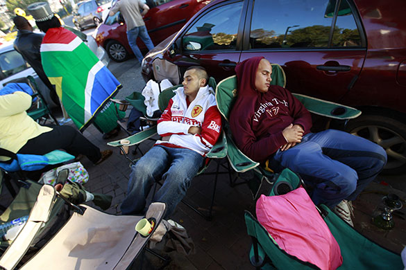 24 hours in pictures: Johannesburg, South Africa: People camp outside a ticket centre in Sandton